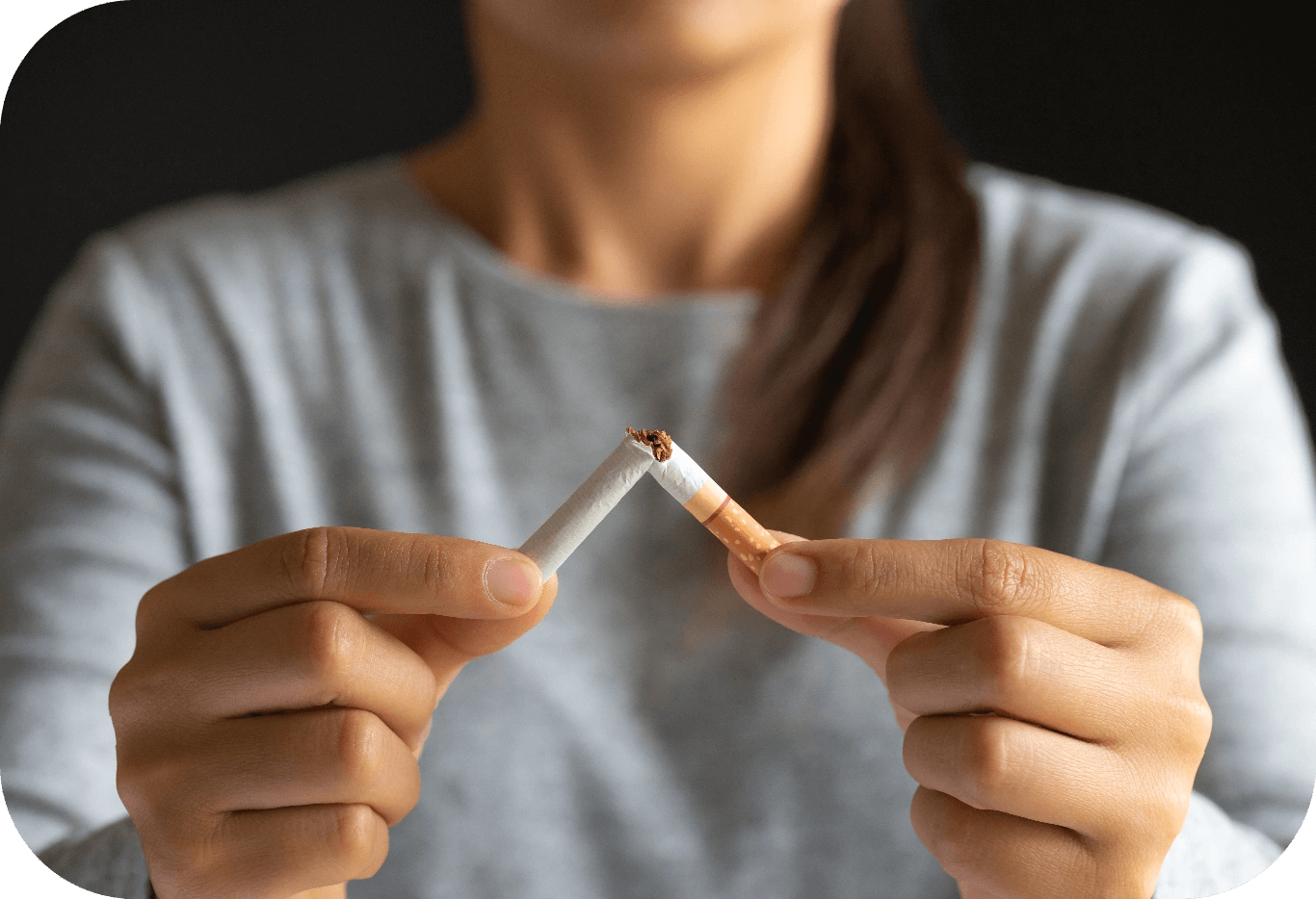 woman-hand-breaking-crushing-destroying-cigarettes-black-background@2x.png